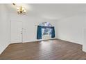 Bright living room features new wood floors and an elegant light fixture at 731 Rising Star Dr, Henderson, NV 89014