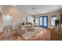 Inviting living room with a cozy seating arrangement, bright doors and neutral decor for a comfortable atmosphere at 1580 Albino Dr, Henderson, NV 89002