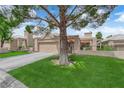Charming single story home with a two car garage and lush green lawn at 328 Wild Plum Ln, Las Vegas, NV 89107