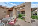 Private outdoor patio with seating, and desert landscaping at 328 Wild Plum Ln, Las Vegas, NV 89107