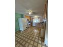 Functional kitchen features linoleum flooring, wooden cabinets, and a window overlooking the backyard at 4244 Gibraltar St, Las Vegas, NV 89121