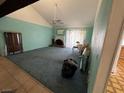 Open living room featuring a fireplace, ceiling fan, and large window with curtains at 4244 Gibraltar St, Las Vegas, NV 89121