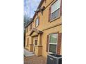 Two-story house featuring neutral exterior, brown shutters, and a covered entry at 4590 Lime Straight Dr, Las Vegas, NV 89115