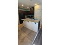 A kitchen island with granite countertop, stainless steel sink, and white base cabinets at 4590 Lime Straight Dr, Las Vegas, NV 89115