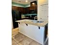 Charming kitchen features granite countertops, an island with a sink, and stainless steel appliances at 4590 Lime Straight Dr, Las Vegas, NV 89115