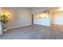 Open living room and kitchen area featuring modern flooring and neutral paint at 8101 W Flamingo Rd # 2059, Las Vegas, NV 89147