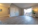 Spacious living room with patio access, high ceilings, and neutral walls at 8101 W Flamingo Rd # 2059, Las Vegas, NV 89147
