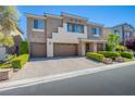 Charming two-story home with a three-car garage and beautifully landscaped front yard at 8303 Saddleback Ledge Ave, Las Vegas, NV 89147