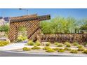 Stone community entrance with modern architectural details, landscaping, and neighborhood signage at 888 Cherry Glen Pl, Las Vegas, NV 89138