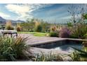 Poolside with desert landscape and water feature at 1123 Christian Rd, Henderson, NV 89002