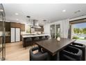 Elegant kitchen featuring an island with bar seating, stainless steel appliances, and seamless access to the outdoor pool area at 11990 Montague St, Las Vegas, NV 89138
