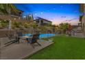 Beautiful backyard with a fire pit, lawn, and pool is perfect for entertaining at 12356 Notch Trail Ave, Las Vegas, NV 89138
