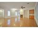 Spacious living room with tile floors, a cozy fireplace, and modern ceiling fan at 2585 Portsmouth Creek Ave, Henderson, NV 89052