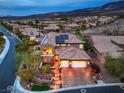 Aerial view of a beautiful home with a tile roof, solar panels, three-car garage, and landscaped yard at 2800 Proust Ct, Henderson, NV 89044