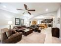 Spacious living room featuring a ceiling fan and seamless flow to the dining area and kitchen at 7119 Saddle Back Peak St, Las Vegas, NV 89166