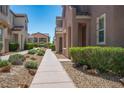 A well-maintained walkway leads to the home, lined with manicured bushes and rocks at 1024 Larkspur Point Ct, Las Vegas, NV 89138