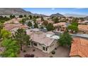 Beautiful aerial view of a single-Gathering home with mature trees and a tile roof in a quiet community at 11013 Mission Lakes Ave, Las Vegas, NV 89134