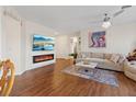Bright and inviting living room featuring hardwood floors, modern fireplace, and stylish décor at 11013 Mission Lakes Ave, Las Vegas, NV 89134