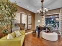 Elegant living room with hardwood floors, a grand piano, and stylish decor at 12056 Royal Dolnoch Ct, Las Vegas, NV 89141