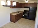 An efficient kitchen showcasing wood cabinets, tile floors, and modern appliances at 212 Orland St # 17, Las Vegas, NV 89107