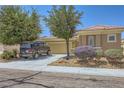 Attractive single-story house exhibiting xeriscaping, a neutral color scheme, and a practical two-car garage at 2213 Carrier Dove Way, North Las Vegas, NV 89084