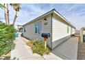 Side view of a cozy home with a well-maintained yard, tidy landscaping, and clear house number at 2323 Mariposa Ave, Las Vegas, NV 89104