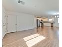 Spacious living room blending into a modern kitchen, with white cabinets and stainless steel appliances at 2323 Mariposa Ave, Las Vegas, NV 89104