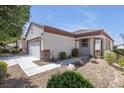 Inviting single-story home with desert landscaping, attached garage, and charming architectural details at 2421 Gamma Ray Pl, Henderson, NV 89044