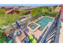 Aerial view of a backyard pool and spa area with a seating area and string lights above the patio at 2733 Auchmull St, Henderson, NV 89044