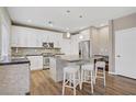 Modern kitchen with white cabinets, stainless steel appliances, and a center island with seating at 3420 Lockport St, Las Vegas, NV 89129