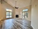 Bright living room featuring vaulted ceilings, wood floors and a cozy fireplace at 3821 Dream St, Las Vegas, NV 89108