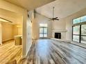 Bright living room featuring vaulted ceilings, wood floors and a cozy fireplace at 3821 Dream St, Las Vegas, NV 89108