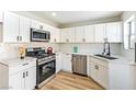 Kitchen with modern appliances, white cabinetry, stainless steel dishwasher, and light countertops at 416 Greenbrook St, Las Vegas, NV 89110