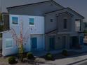 A two-story townhome featuring modern architecture, a front entrance, and green landscaping at 4566 Mansart Ct # 1104, North Las Vegas, NV 89031