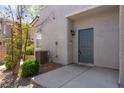 Inviting front entrance with a well-manicured shrub, walkway, and a stylish blue door at 4566 Mansart Ct # 1104, North Las Vegas, NV 89031