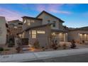 Beautiful two-story home with desert landscaping, a private gate, and a modern gray exterior at 461 Cascade Heights Ave, Las Vegas, NV 89138