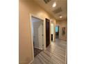 Hallway with tile flooring, neutral walls, and views into other rooms at 4837 Skyraider St, North Las Vegas, NV 89031