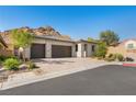 Beautiful single-story home with a three-car garage, desert landscaping, and mountain views at 50 Barrio Alto Ct, Henderson, NV 89011