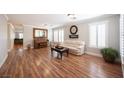 A spacious living room featuring hardwood floors, white trim and neutral paint at 5000 Charlo Dr, Las Vegas, NV 89131