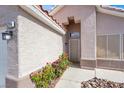 Inviting home entrance with a secure screen door and lovely floral accents at 5244 Velazco Ln, Las Vegas, NV 89130