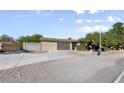 Ranch-style house featuring an attached two-car garage and expansive driveway at 5518 Avenida Vaquero, Las Vegas, NV 89108