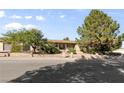 Charming single-story home with a lush front yard and mature shade trees at 5518 Avenida Vaquero, Las Vegas, NV 89108