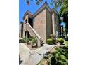 Lovely condo featuring two stories, stucco walls, outdoor stairs, and decorative rock and shrub landscaping at 5525 W Flamingo Rd # 2037, Las Vegas, NV 89103