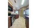 Open kitchen featuring stainless steel appliances, granite countertops and tile floors at 5525 W Flamingo Rd # 2037, Las Vegas, NV 89103