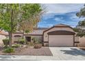 Inviting single-story home showcasing a well-maintained yard and an attached two-car garage at 6048 Pele St, North Las Vegas, NV 89031