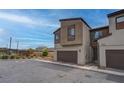 Modern two-story home with a two-car garage surrounded by landscaped greenery and a clear sky at 6148 Juniper Grove St, Las Vegas, NV 89148