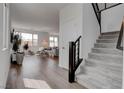 Bright, airy living room with hardwood floors, lots of natural light, and open staircase at 6148 Juniper Grove St, Las Vegas, NV 89148