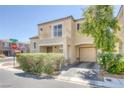 Tan two-story home with a balcony over the entryway and an attached two-car garage at 6217 Lapilli Ave, Las Vegas, NV 89139