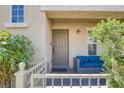 Inviting front porch featuring modern seating, plants, and a well-maintained walkway at 6217 Lapilli Ave, Las Vegas, NV 89139