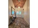 Inviting entryway featuring tiled floors, a decorative mirror, and a stylish light fixture at 6435 Heatherton Ave, Las Vegas, NV 89110